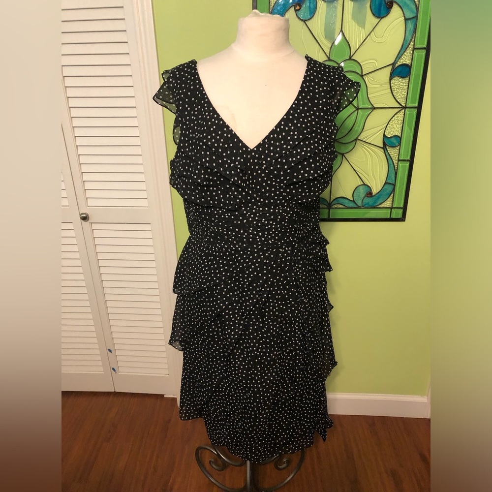 Overlapping layers of subtle ruffles and fully lined polyester crepe